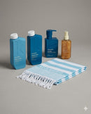 Set of Kevin Murphy Repair products including bottles and a towel on a gray background - Hair Care Canada