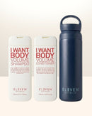 Two bottles of 'I Want Body Volume' shampoo and conditioner by Eleven Australia, with a navy water bottle - Hair Care Canada